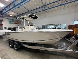 2025 Mako 214 CC boat on trailer in showroom, featuring sleek design and modern build.