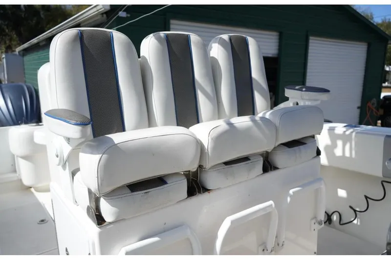  Yacht Photos Pics 2000 Contender 36 Open boat with white cushioned seats and armrests.