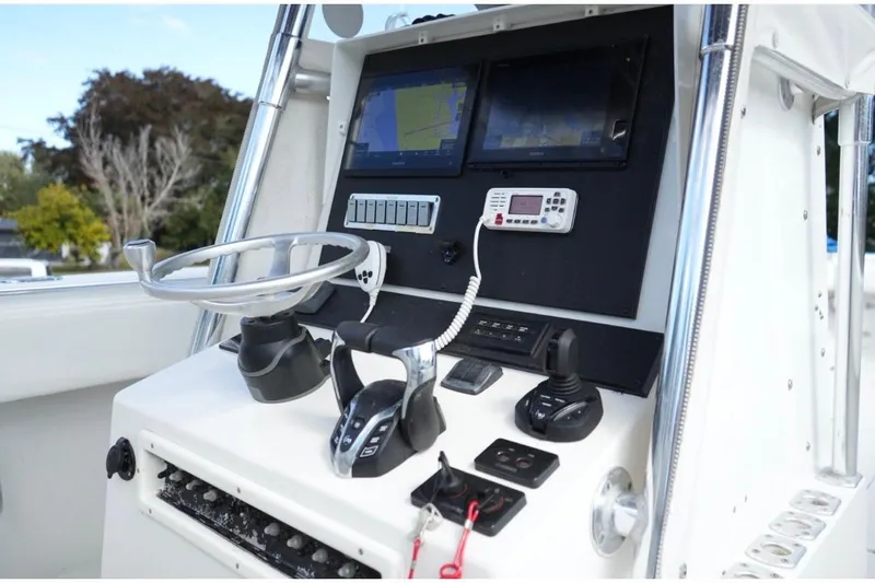  Yacht Photos Pics Control panel of a 2000 Contender 36 Open boat with steering wheel and navigation screens.