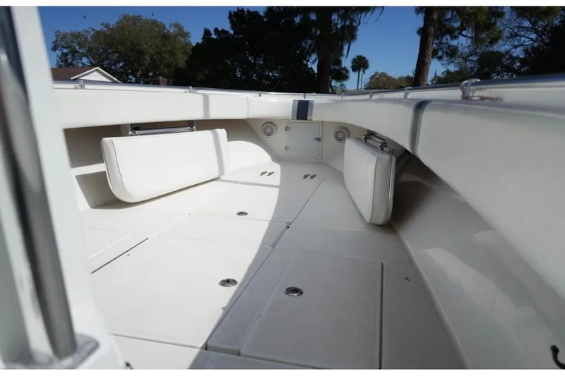  Yacht Photos Pics 2000 Contender 36 Open boat interior with white seating and storage compartments.