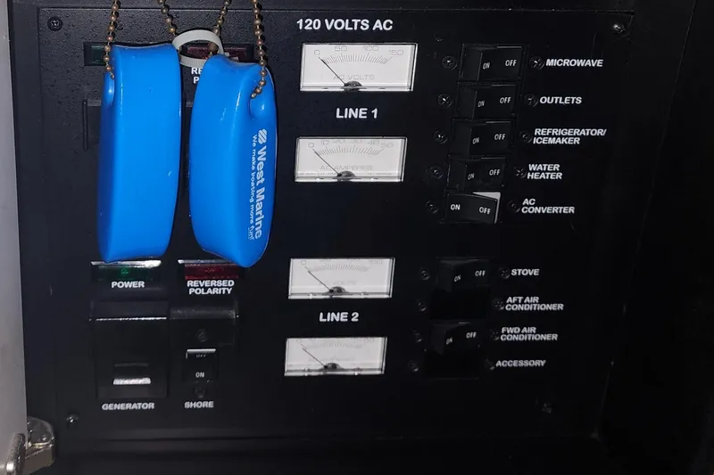 Keep The Faith Yacht Photos Pics Electrical panel of 2005 Sea Ray 340 Sundancer boat with switches and blue key floats.