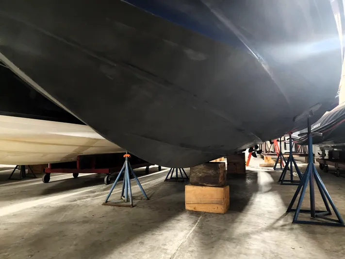 Keep The Faith Yacht Photos Pics 2005 Sea Ray 340 Sundancer boat hull on stands in storage facility.