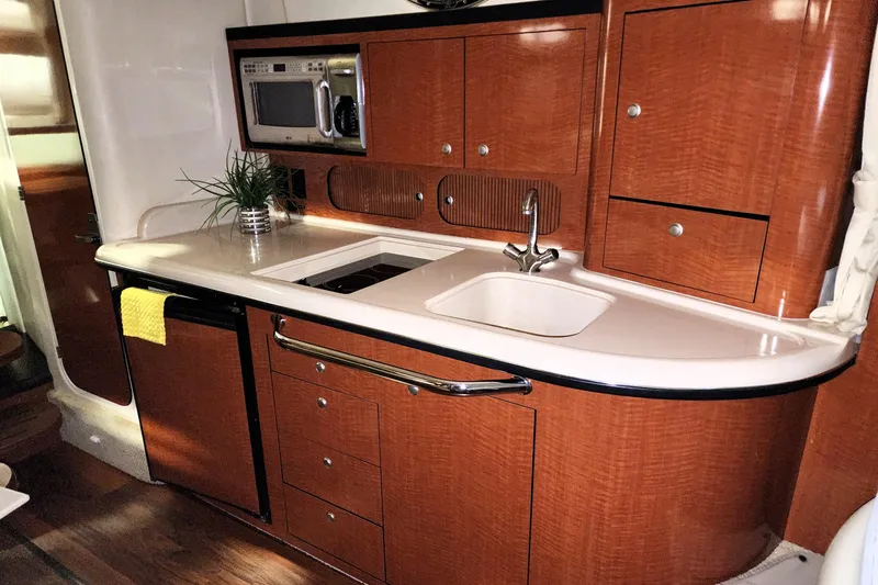Keep The Faith Yacht Photos Pics 2005 Sea Ray 340 Sundancer galley with wood cabinetry, sink, and microwave.