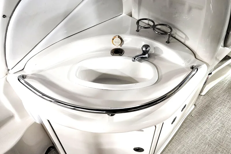 Keep The Faith Yacht Photos Pics 2005 Sea Ray 340 Sundancer bathroom sink with chrome faucet and cup holders.