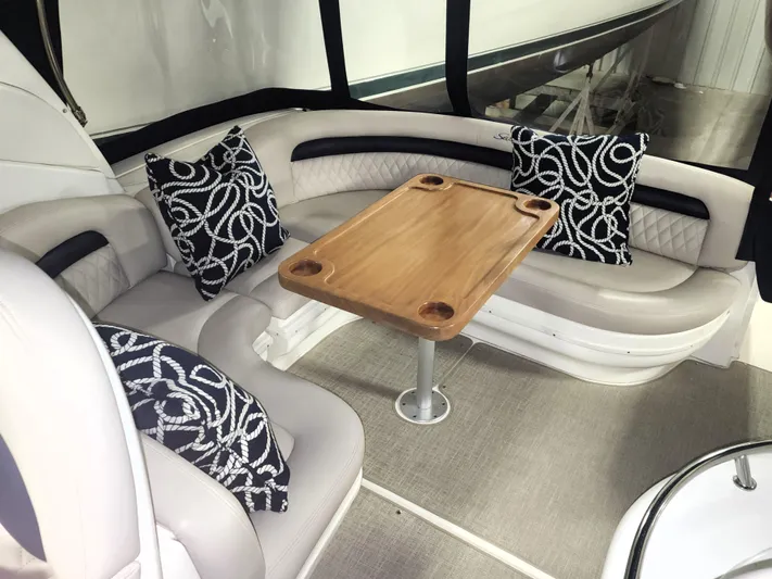 Keep The Faith Yacht Photos Pics Interior of 2005 Sea Ray 340 Sundancer with cushioned seating and wooden table.