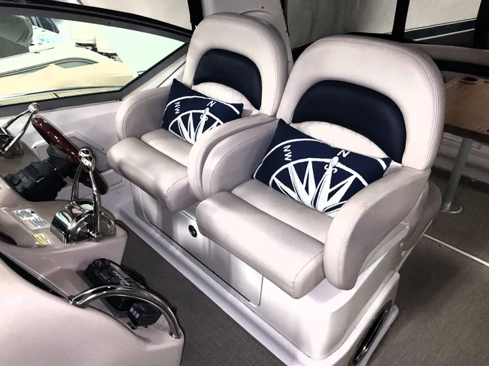 Keep The Faith Yacht Photos Pics 2005 Sea Ray 340 Sundancer helm with dual seats and nautical-themed cushions.