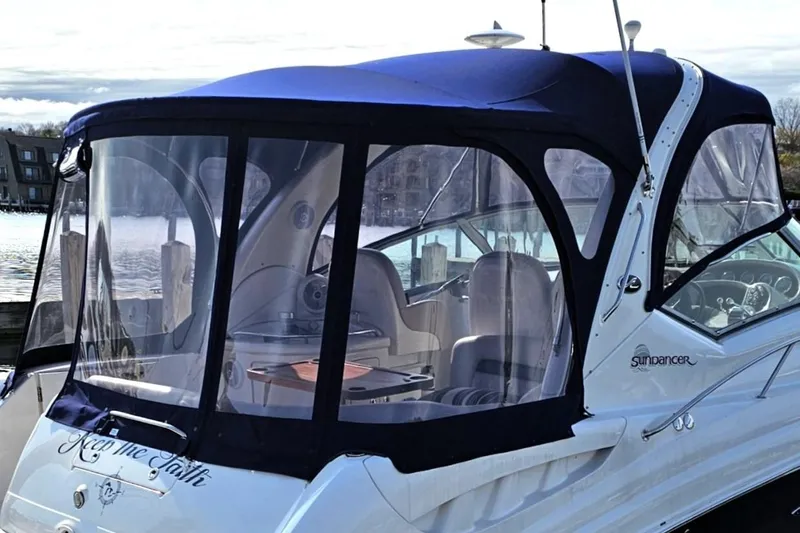 Keep The Faith Yacht Photos Pics 2005 Sea Ray 340 Sundancer boat with blue canopy docked at marina.