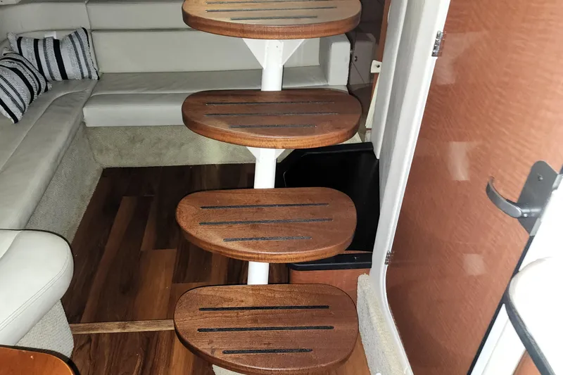 Keep The Faith Yacht Photos Pics Interior stairs of 2005 Sea Ray 340 Sundancer yacht with wooden steps.