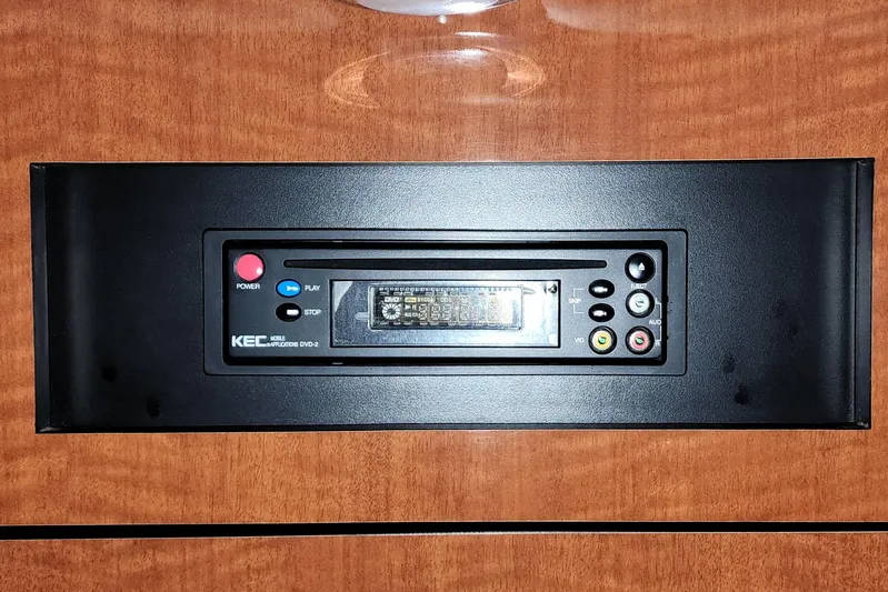 Keep The Faith Yacht Photos Pics KEC DVD player in 2005 Sea Ray 340 Sundancer boat, mounted on wooden panel.