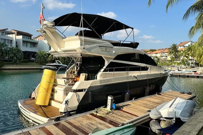  Yacht Photos Pics 2012 Fairline Squadron 50 yacht docked in a sunny marina, surrounded by palm trees.