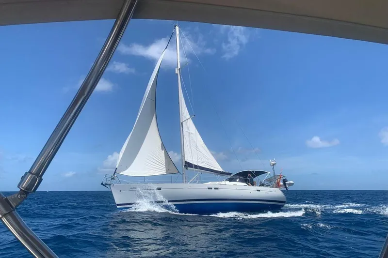 Laylay Yacht Photos Pics Sailing yacht Beneteau Oceanis Clipper 473, 2003 model, cruising on open sea under clear skies.