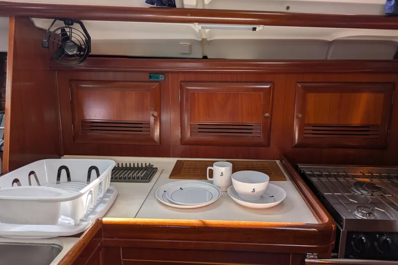 Laylay Yacht Photos Pics Galley of 2003 Beneteau Oceanis Clipper 473 with wooden cabinets and kitchenware.