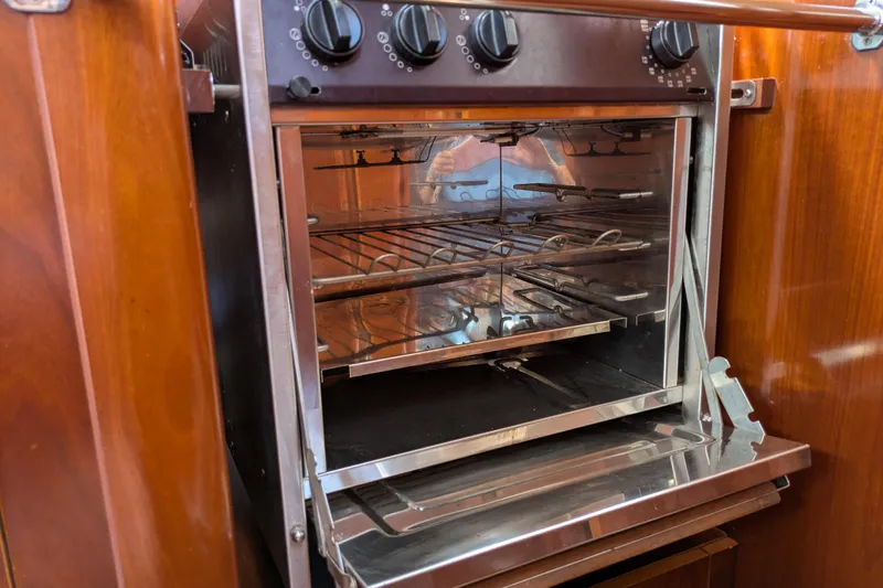 Laylay Yacht Photos Pics Galley oven inside 2003 Beneteau Oceanis Clipper 473 yacht, featuring stainless steel interior.