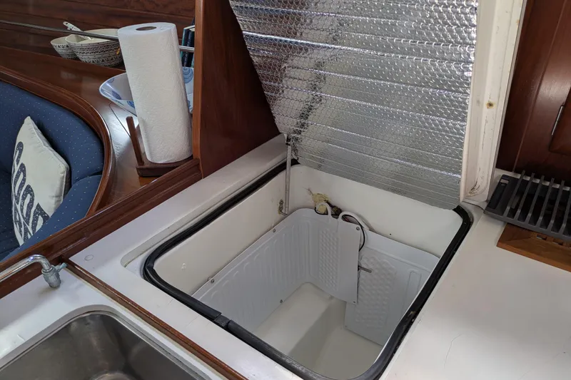 Laylay Yacht Photos Pics Open storage compartment in 2003 Beneteau Oceanis Clipper 473 yacht kitchen area.