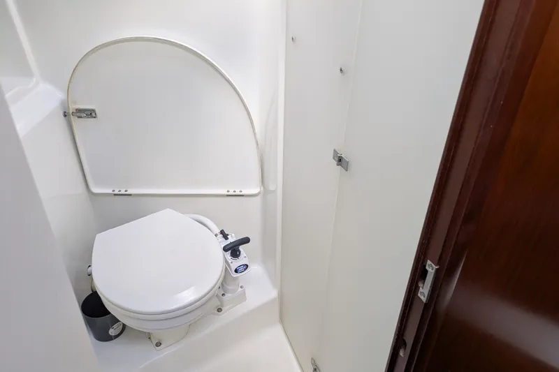 Laylay Yacht Photos Pics Bathroom of 2003 Beneteau Oceanis Clipper 473 yacht, featuring a compact marine toilet.