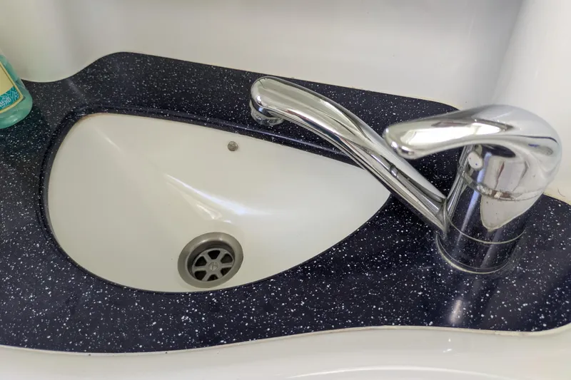 Laylay Yacht Photos Pics Chrome faucet and speckled countertop on 2003 Beneteau Oceanis Clipper 473 yacht.