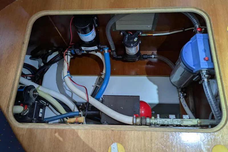 Laylay Yacht Photos Pics Engine compartment of 2003 Beneteau Oceanis Clipper 473 with visible plumbing and wiring.