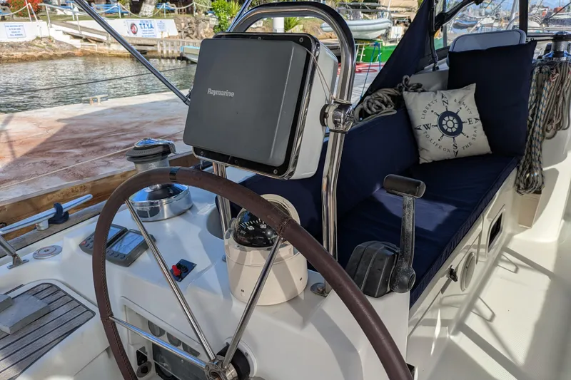 Laylay Yacht Photos Pics Cockpit of 2003 Beneteau Oceanis Clipper 473 sailboat with steering wheel and navigation equipment.