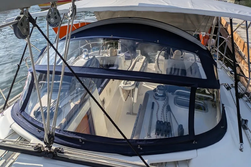 Laylay Yacht Photos Pics 2003 Beneteau Oceanis Clipper 473 sailboat cockpit with protective canopy and visible rigging.