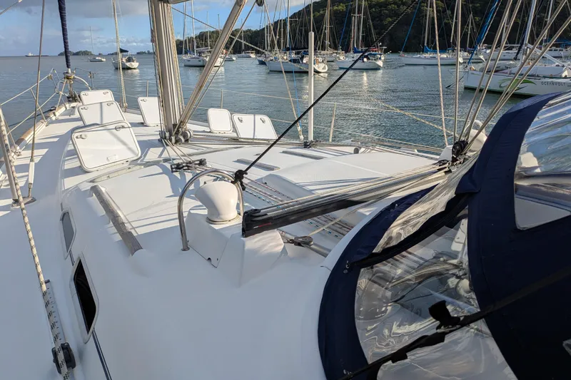 Laylay Yacht Photos Pics Deck view of a 2003 Beneteau Oceanis Clipper 473 sailboat in a marina.