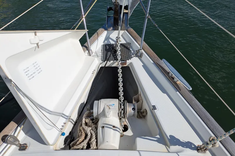 Laylay Yacht Photos Pics Anchor chain locker on 2003 Beneteau Oceanis Clipper 473 sailboat, open with visible chain and rope.