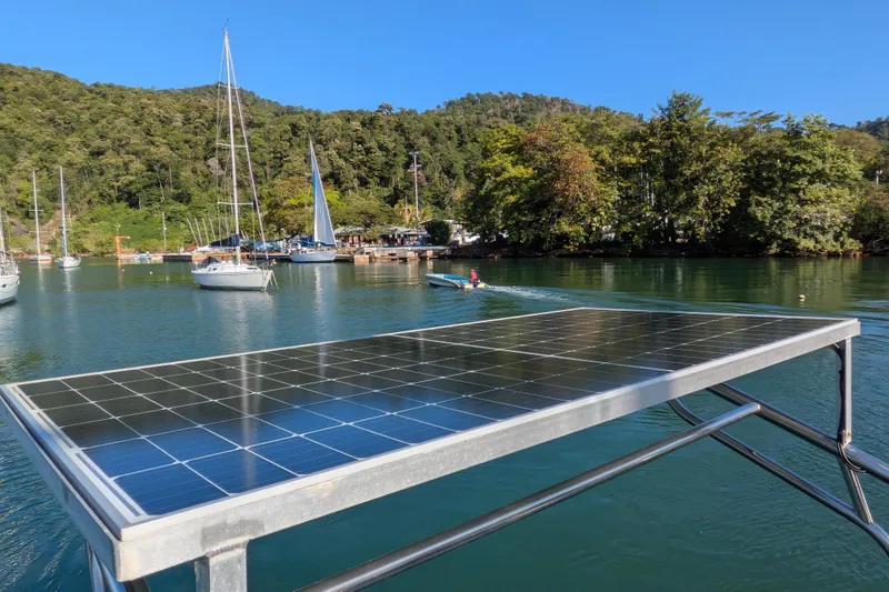 Laylay Yacht Photos Pics Solar panel on a 2003 Beneteau Oceanis Clipper 473, docked in a scenic marina.