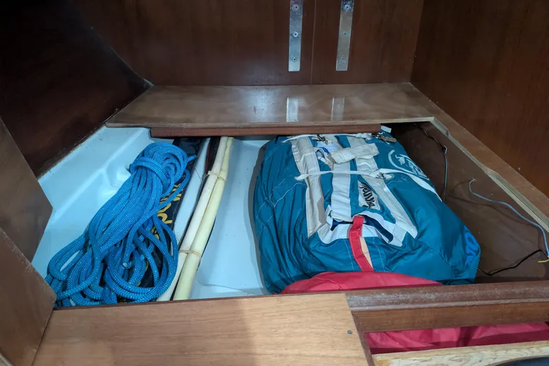 Laylay Yacht Photos Pics Storage compartment in a 2003 Beneteau Oceanis Clipper 473 with ropes and gear.