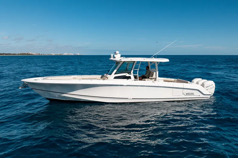  Yacht Photos Pics 2019 Boston Whaler 380 Outrage boat cruising on open blue sea.
