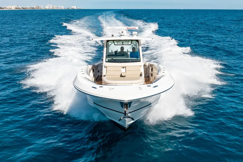  Yacht Photos Pics 2019 Boston Whaler 380 Outrage cruising on open blue ocean waters.