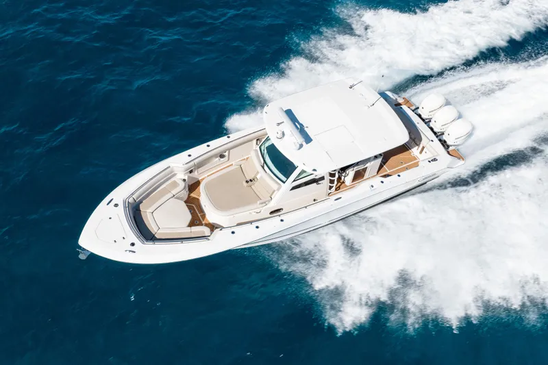  Yacht Photos Pics 2019 Boston Whaler 380 Outrage cruising on blue ocean waters, aerial view.