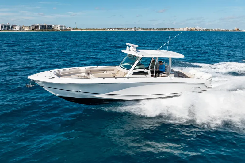  Yacht Photos Pics 2019 Boston Whaler 380 Outrage cruising on blue ocean near coastline.