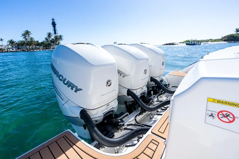  Yacht Photos Pics 2019 Boston Whaler 380 Outrage with triple Mercury outboard engines on blue water.