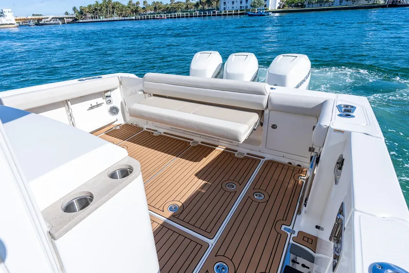  Yacht Photos Pics 2019 Boston Whaler 380 Outrage boat with spacious deck and triple engines on blue water.