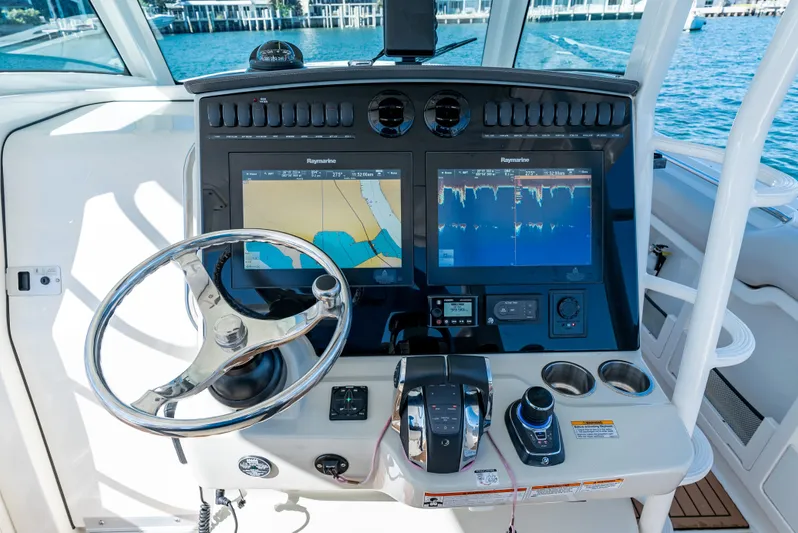  Yacht Photos Pics 2019 Boston Whaler 380 Outrage helm with dual navigation screens and steering wheel.