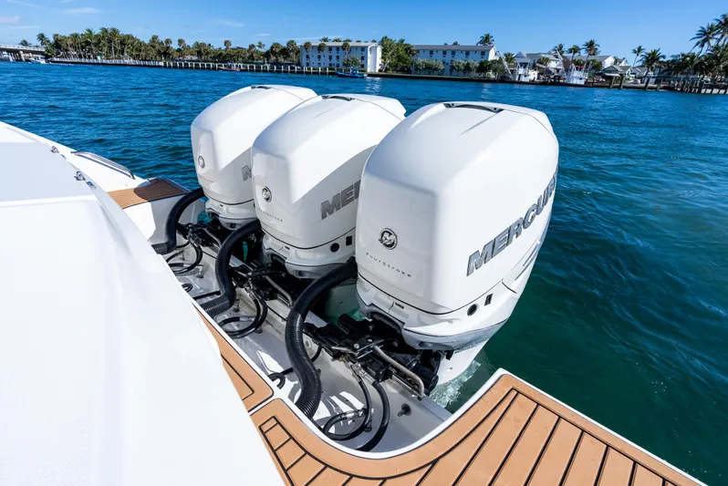  Yacht Photos Pics 2019 Boston Whaler 380 Outrage with triple Mercury outboard engines on blue water.