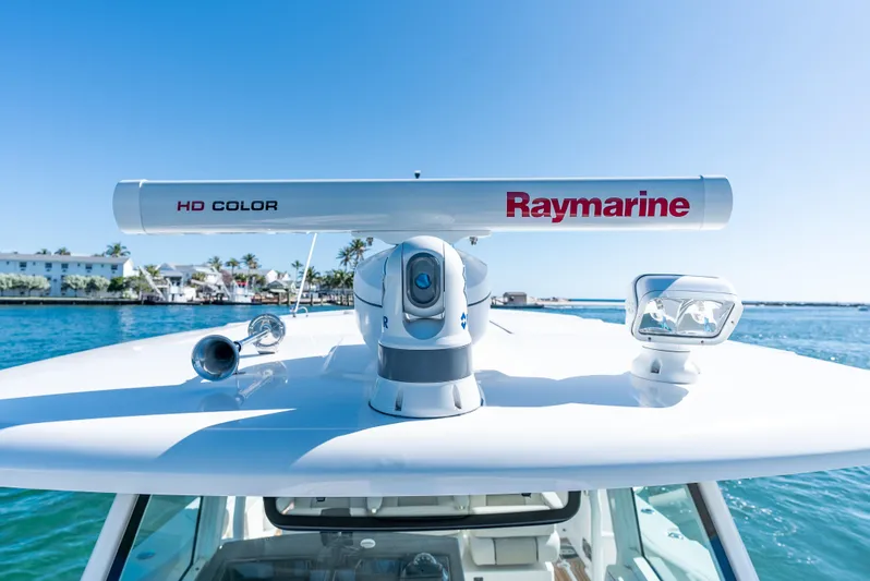  Yacht Photos Pics 2019 Boston Whaler 380 Outrage with Raymarine radar on blue water background.