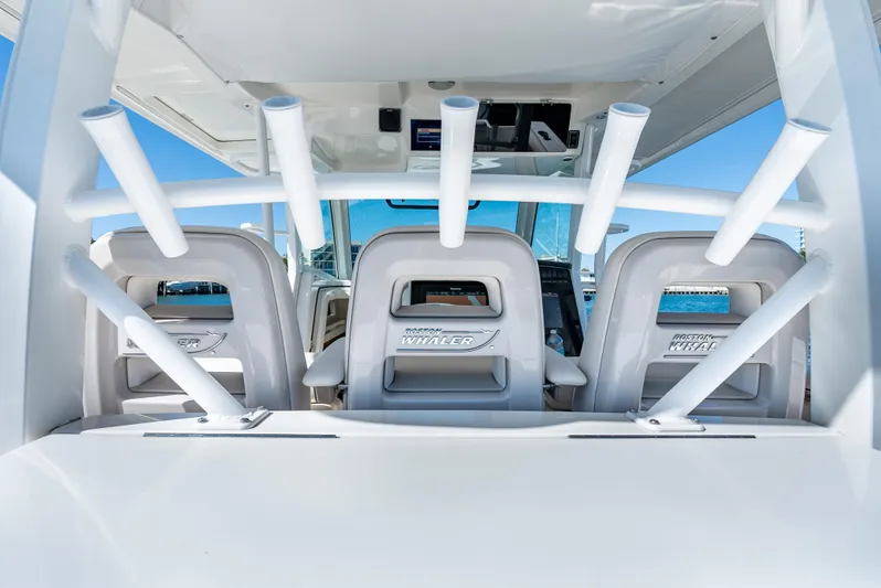  Yacht Photos Pics 2019 Boston Whaler 380 Outrage boat interior with rod holders and seating.
