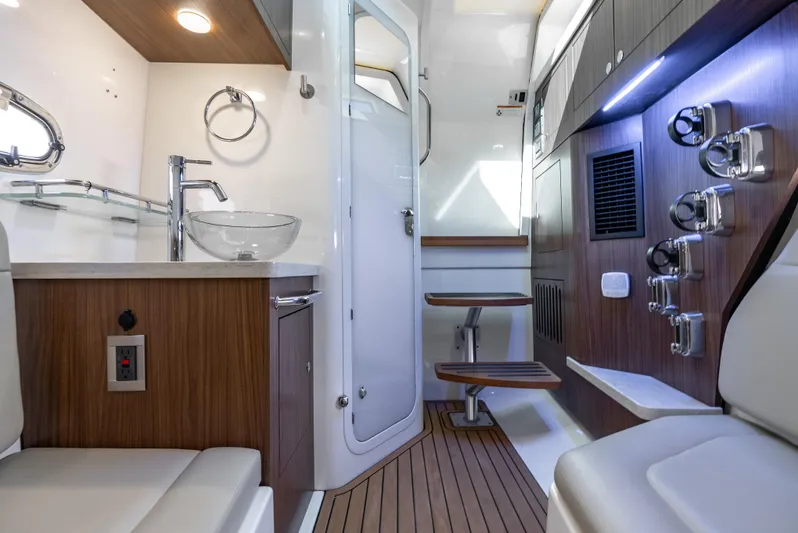  Yacht Photos Pics Luxurious interior of 2019 Boston Whaler 380 Outrage, featuring modern amenities and elegant wood finishes.