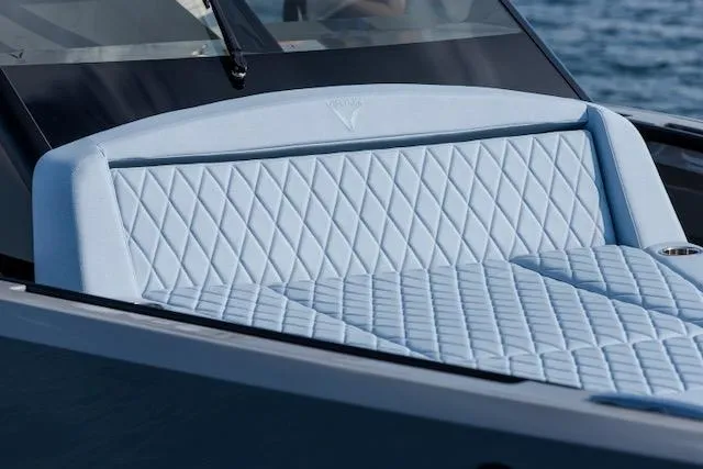  Yacht Photos Pics Luxurious 2026 Virtue V10 boat with quilted seating, sleek design, and ocean backdrop.