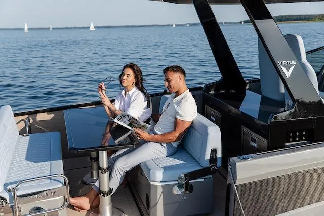  Yacht Photos Pics Couple relaxing on a 2026 Virtue V10 yacht, enjoying a sunny day on the water.