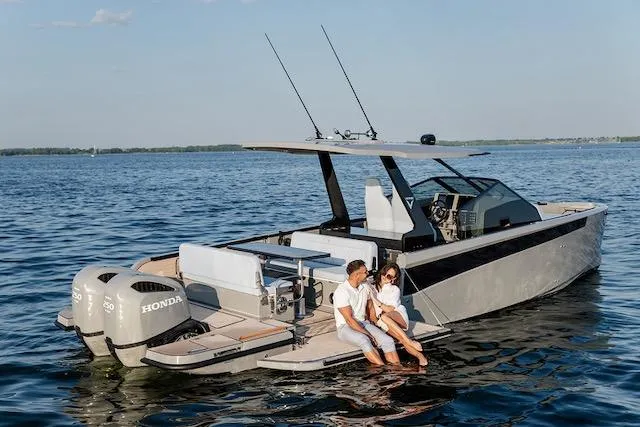  Yacht Photos Pics Couple relaxing on a 2026 Virtue V10 boat with dual Honda engines on a serene lake.