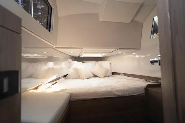  Yacht Photos Pics Cozy interior cabin of 2026 Virtue V10 yacht with plush bedding and natural light.