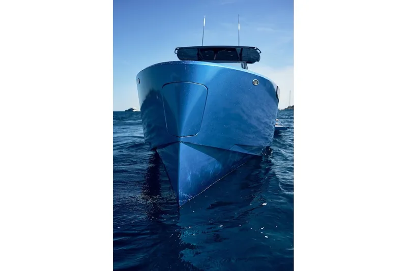  Yacht Photos Pics 2026 Virtue V10 T-Top boat on calm blue water, front view.