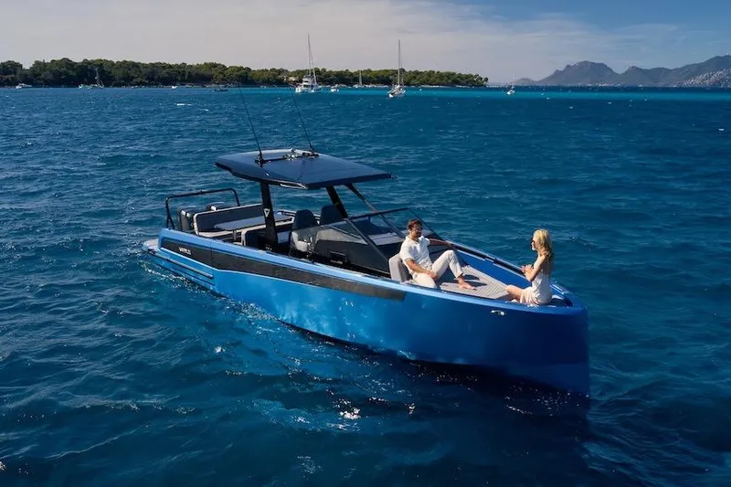  Yacht Photos Pics 2026 Virtue V10 T-Top boat cruising on blue ocean with two people relaxing onboard.
