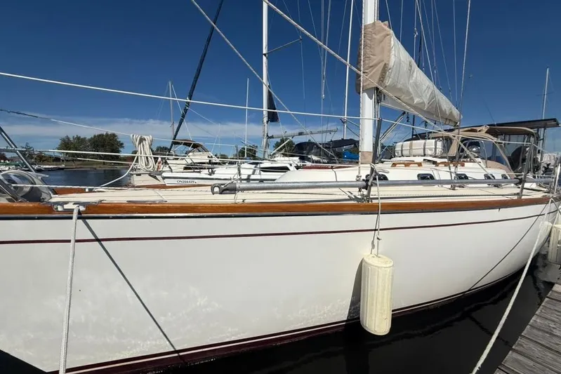  Yacht Photos Pics 1998 Tartan 3500 sailboat docked at marina under clear blue sky.