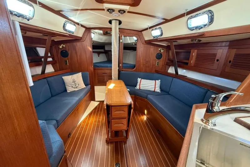  Yacht Photos Pics Interior of 1998 Tartan 3500 sailboat with wooden finish and blue seating.
