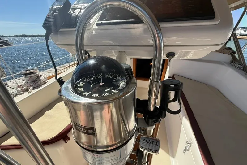  Yacht Photos Pics Compass and controls on a 1998 Tartan 3500 sailboat, docked by the water.