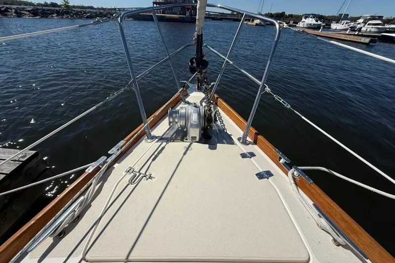  Yacht Photos Pics Bow of 1998 Tartan 3500 sailboat docked at marina, with clear water view.