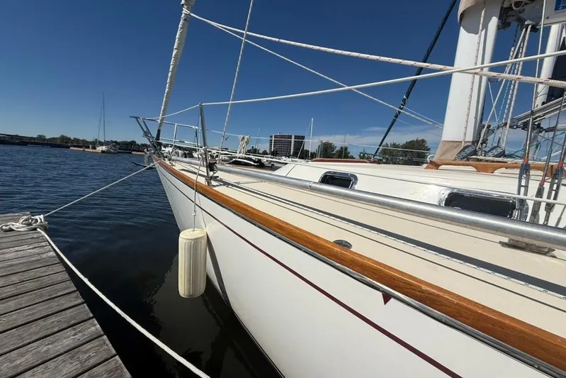  Yacht Photos Pics Sailboat docked at marina, Tartan 3500 model, 1998, with clear blue sky.