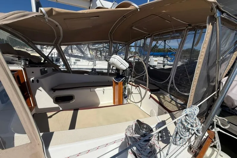  Yacht Photos Pics 1998 Tartan 3500 sailboat cockpit with beige canopy and ropes, docked at marina.